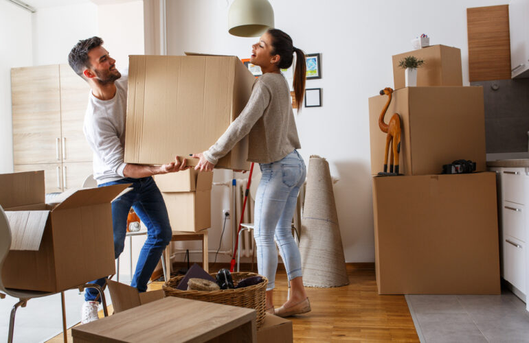 Image of a person and person holding a box for moving house