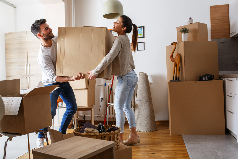 Image of a person and person holding a box for moving house