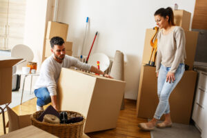 Image of a person and person in a room with boxes for moving house 